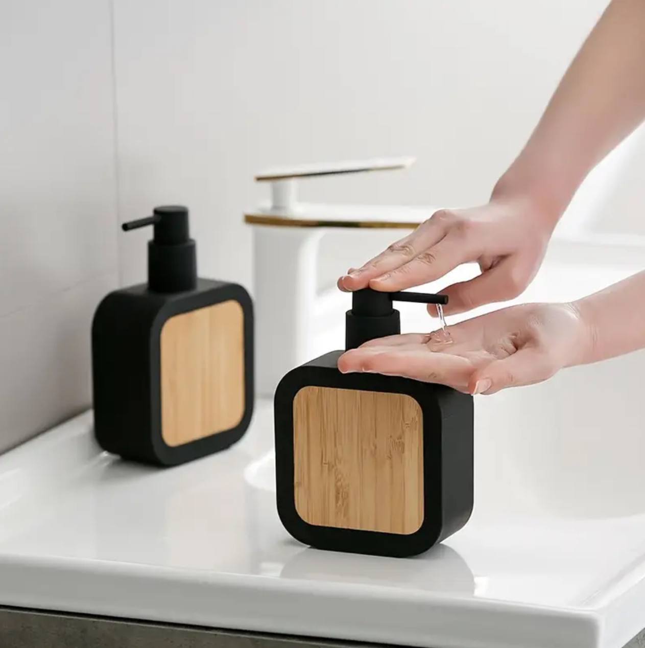Square plastic soap dispenser with bamboo accent pump.