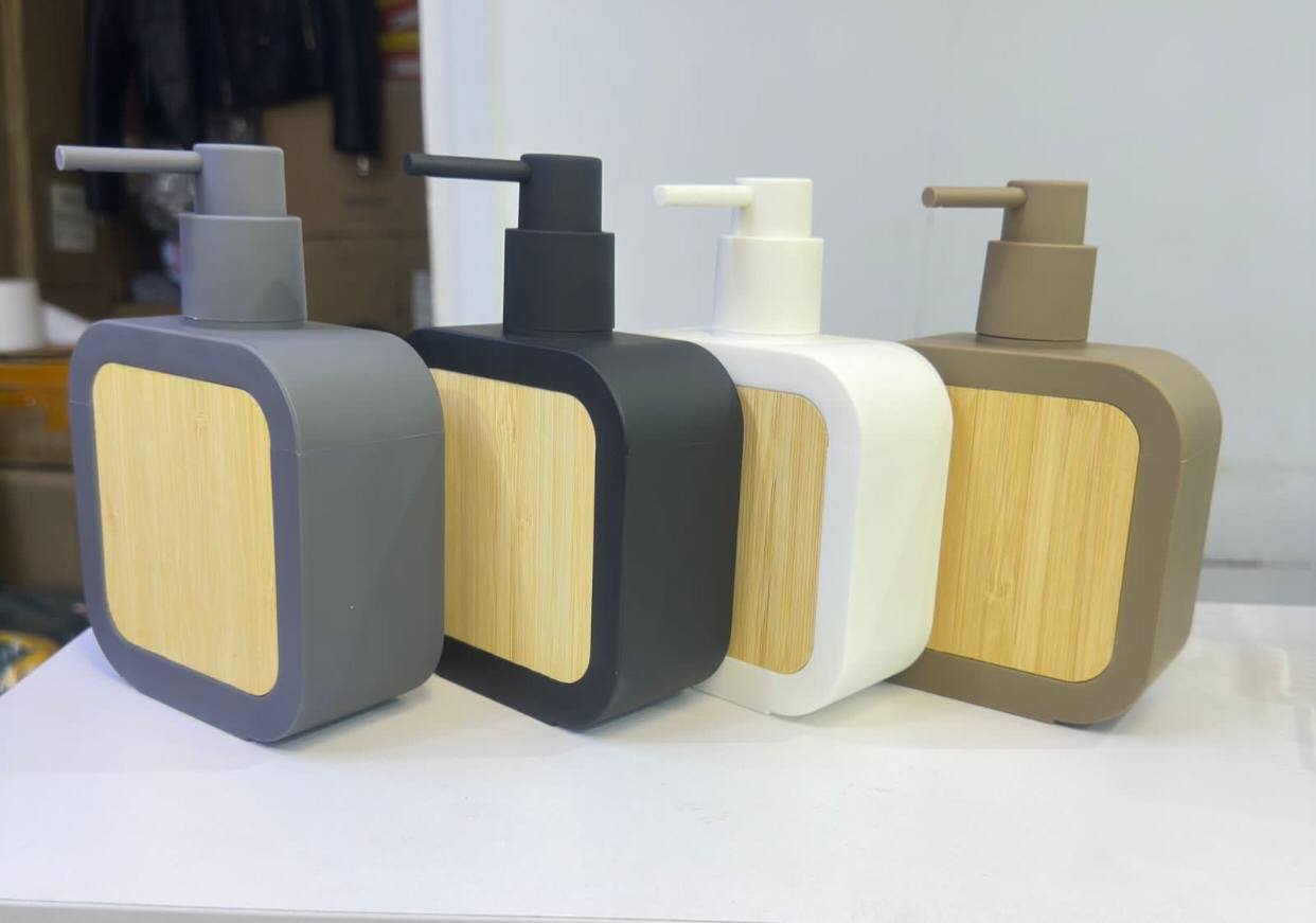 Square plastic soap dispenser with bamboo accent pump
