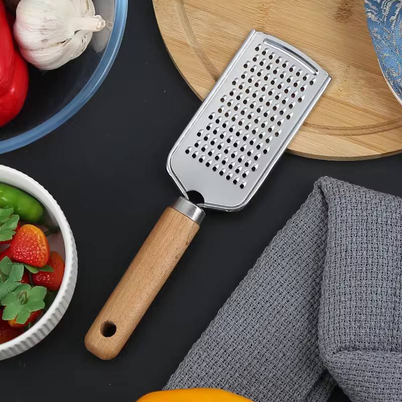Stainless steel multipurpose grater 
With wooden handle